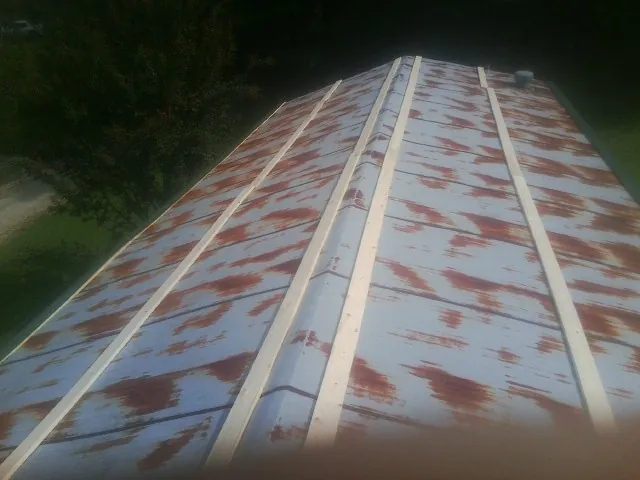 Rusted metal roof panels with new wood purlins before replacement — Storm Damage Roof Repair in Stratford by Roofing Brothers